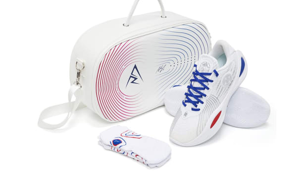 Side view of Austin Reaves' white, blue, and red sneakers.